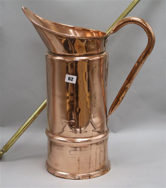 A copper jug, a brass towel rail and a pair of candlesticks